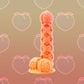 The Peach Pie Fantasy Dildo features a juicy bulbous tip, and a lattice textured shaft  filled with crevices and ridges. 